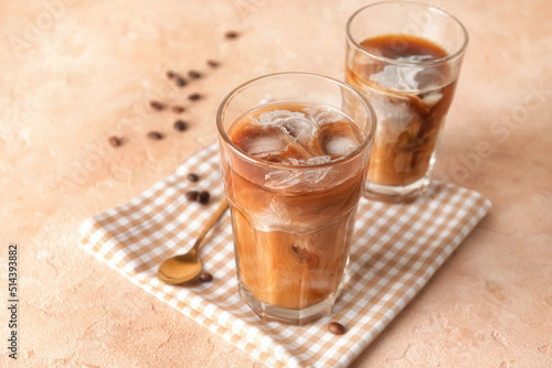 Glasses of cold brew coffee on beige table