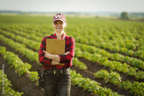 Confident mature farmer in agricultural field. Potato field.