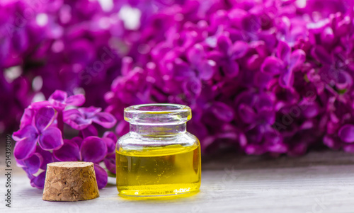 Lilac essential oil in a small bottle. Selective focus.