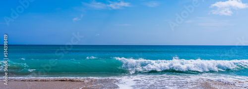 Fototapeta Naklejka Na Ścianę i Meble -  Panorama of a turquoise wave with white foam on a sandy ocean beach in Melbourne Beach, Florida