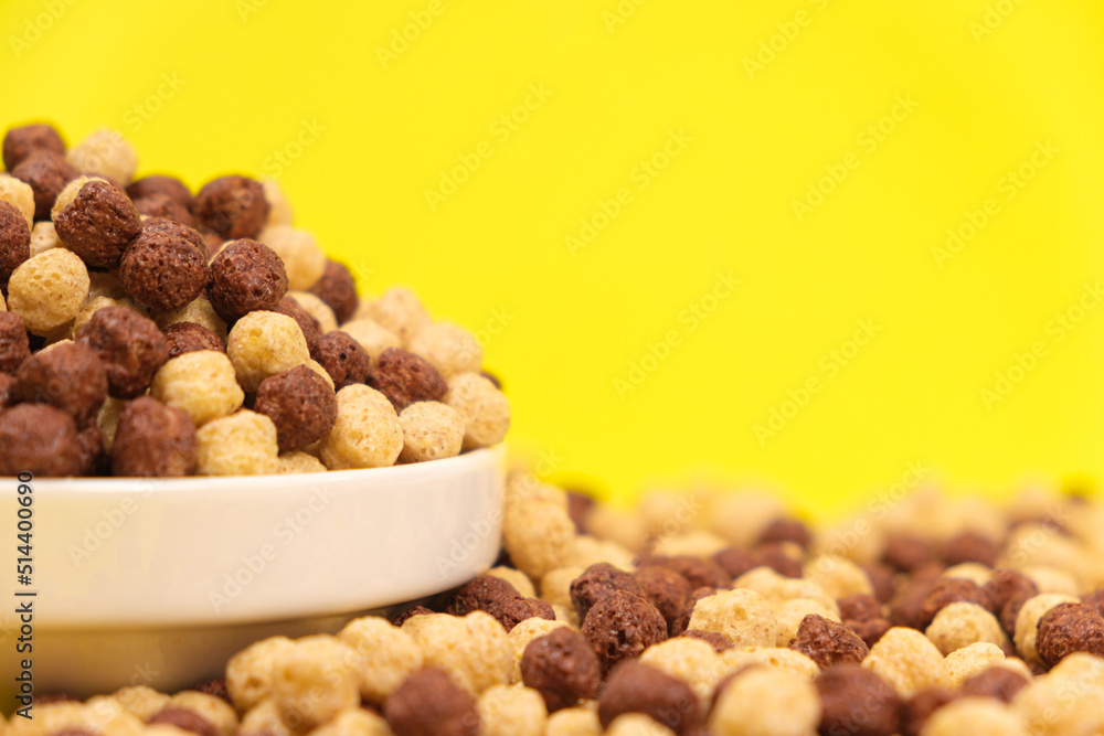 Corn sweet balls on a yellow background. Quick dry breakfasts, side view. Corn sweet balls on a yellow background. Quick dry breakfasts, side view.