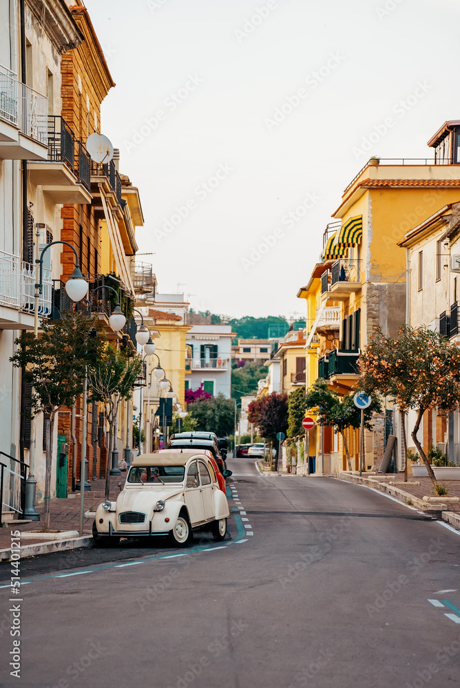 Typical italian street with old car in Scauri, Italy.
