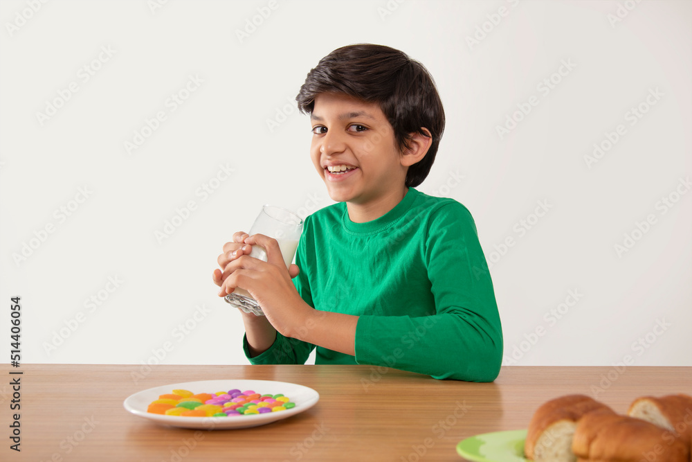 Portrait of smiling boy drinking milk during breakfast Portrait of smiling boy drinking milk during breakfast