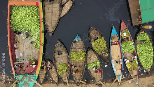 Aerial view of people working on commercial boats with fruits, Buriganga river, Keraniganj, Dhaka, Bangladesh. photo