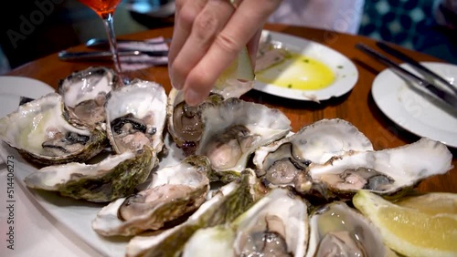 Fresh oysters with ice, lemon on a plate in a restaurant in Barcelona, Spain