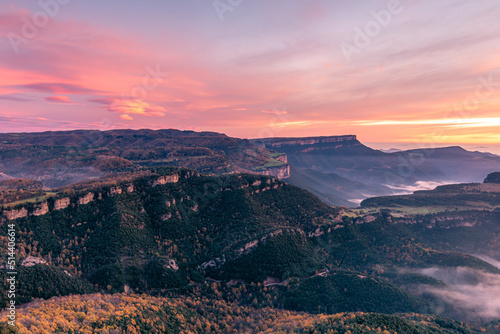 Beautiful sunrise on the edge of the mountain cliffs.