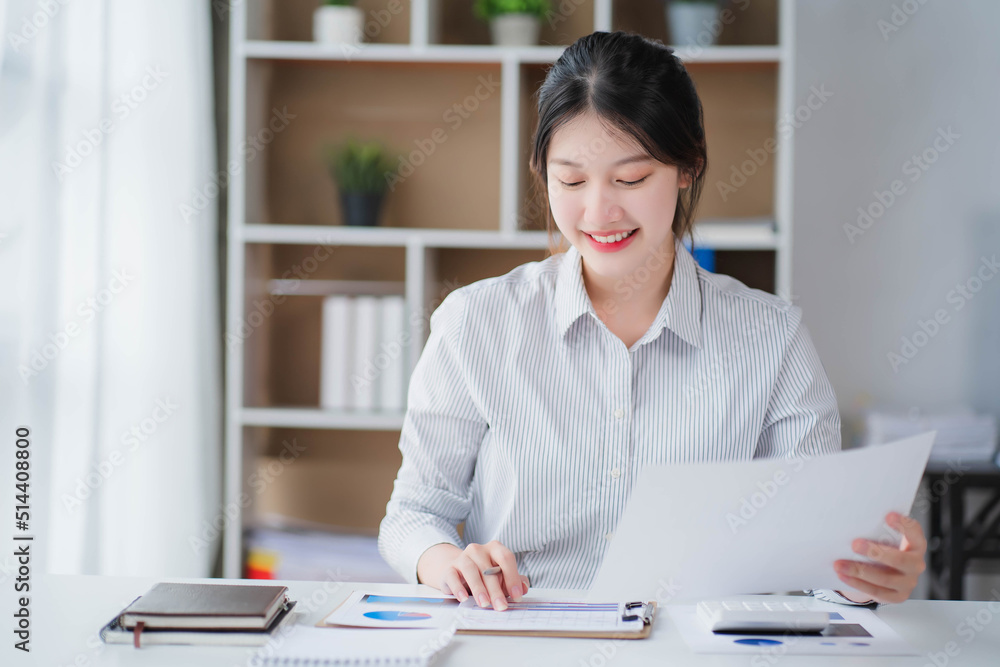 Young asian businesswoman beautiful charming smiling and talking on the mobile phone in the office Young asian businesswoman beautiful charming smiling and talking on the mobile phone in the office