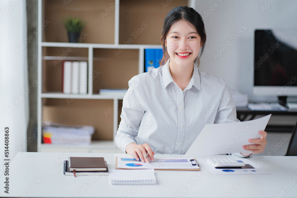 Young asian businesswoman beautiful charming smiling and talking on the mobile phone in the office Young asian businesswoman beautiful charming smiling and talking on the mobile phone in the office