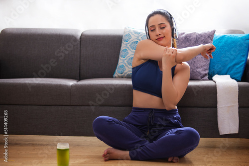 Young woman doing exercise on the floor in living room