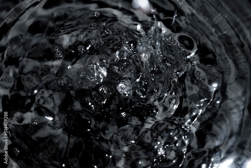 Abstract black water surface background. Dark splashes abstract background.