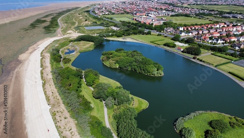 Aerial view of Fairhaven lake in Lytham St Annes with views of the coast in the background.  photo