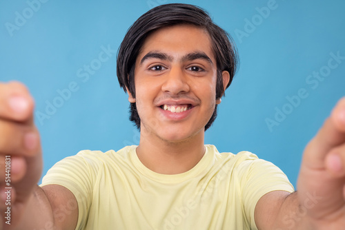 Close-up portrait of a teenage boy taking selfie