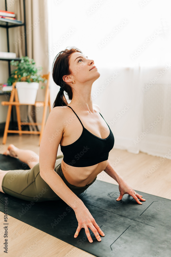 Fit woman in sportswear doing workout yoga burning fat calories training strength practicing effort Fit woman in sportswear doing workout yoga burning fat calories training strength practicing effort