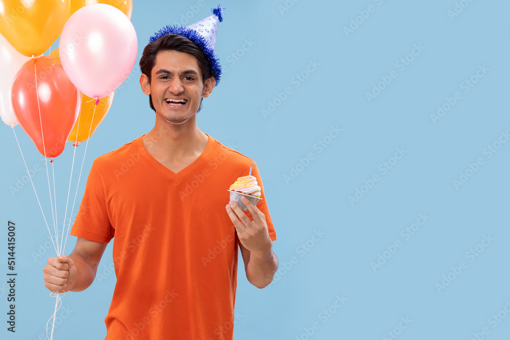 Portrait of cheerful boy in birthday hat standing with balloons and cake Portrait of cheerful boy in birthday hat standing with balloons and cake