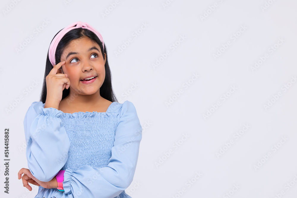 Portrait of thoughtful girl with hand on head standing against plain background Portrait of thoughtful girl with hand on head standing against plain background