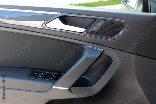 Lux Car interior. Car door trim, door handle and control buttons. Front door panel. Lux car door handle and control buttons. © Best Auto Photo