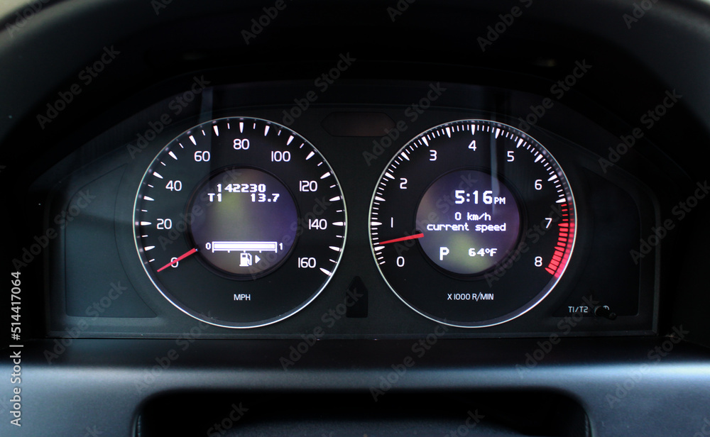 Car Dashboard. Close up image of illuminated car dashboard. Odometer of car. Odometer, speedometer, tachometer, fuel level, water temperature and more. Car Dashboard. Close up image of illuminated car dashboard. Odometer of car. Odometer, speedometer, tachometer, fuel level, water temperature and more.