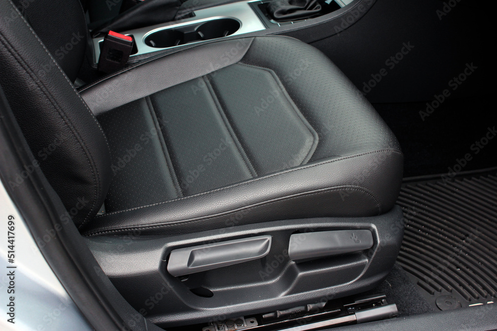 Detail of new modern car interior, Focus on seat adjust switch. The driver seat of a luxury business class car. Car seat manual adjust stick panel to control seat position in passenger car. 