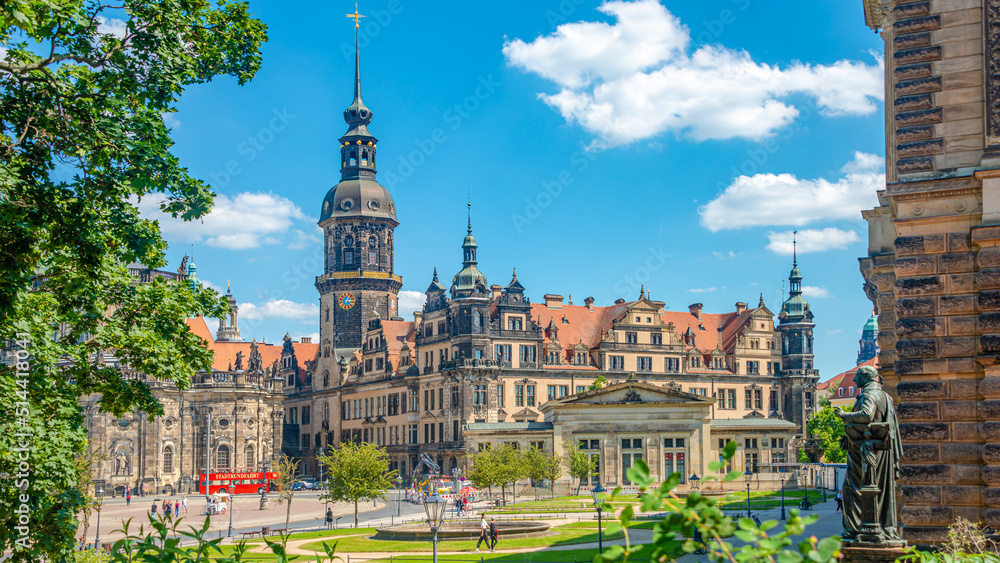 Cityscape over historical and touristic center in Dresden downtown, old clock tower near Cathedral of Holy Trinity and theater square, Dresden, Germany, at summer sunny day and blue sky. Cityscape over historical and touristic center in Dresden downtown, old clock tower near Cathedral of Holy Trinity and theater square, Dresden, Germany, at summer sunny day and blue sky.