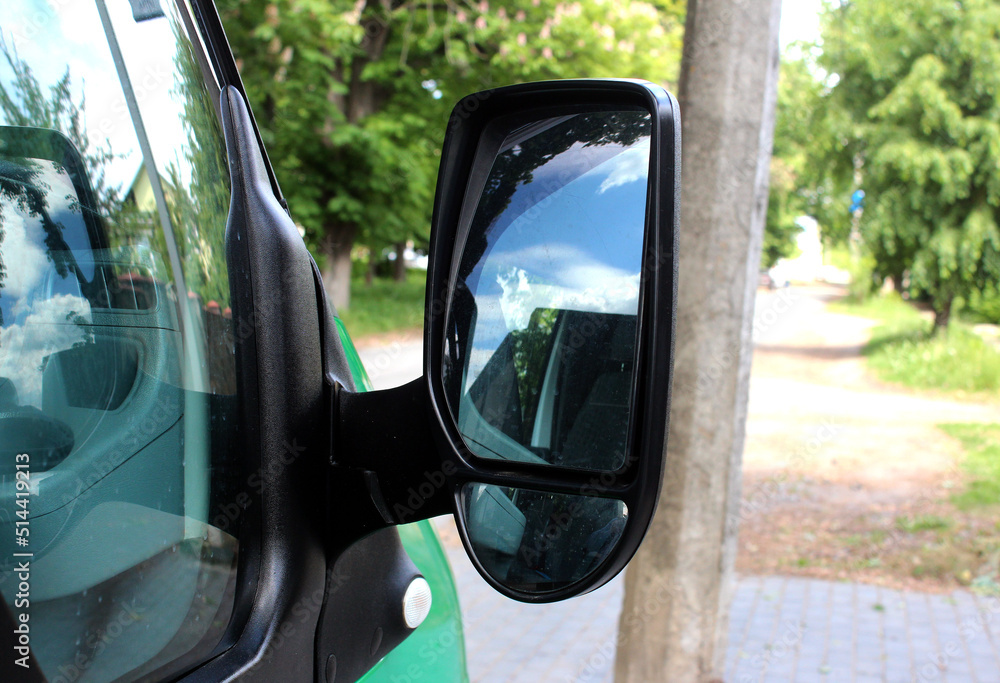 Moder cargo van rearview mirror. Black rear view mirror with reflection in it. Accessory for vehicles to look back on road for good visibility and drive car safely. Moder cargo van rearview mirror. Black rear view mirror with reflection in it. Accessory for vehicles to look back on road for good visibility and drive car safely.