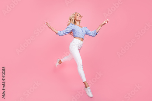 Full length photo of pretty sweet lady wear off shoulders top jumping high looking empty space isolated pink color background