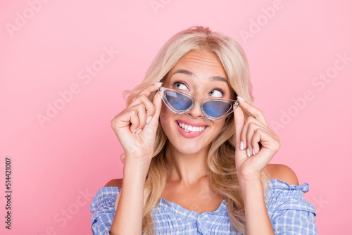 Photo of funny dreamy lady wear off shoulders top arms hands dark glasses looking empty space isolated pink color background