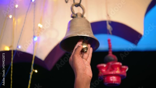 Hindu Temple Ringer Bell Closeup | Brass made bell is being rang by a person | Indian religious background  photo