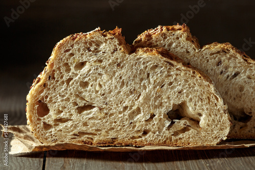 Fotobehang Bread, traditional sourdough bread cut into slices on a rustic wooden background