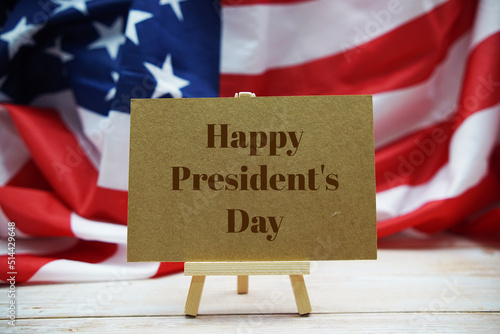Happy President's Day text messege with USA flag on wooden background