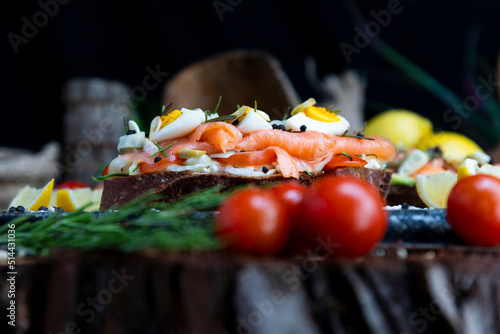 Salted salmon open sandwich with eggs, tomatoes, olives, cream cheese, cucumber and garlick. Healthy seafood