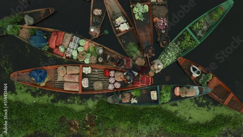 Rainawari, India - 03 June 2022: Aerial view of People on typical boats along the river during the floating market, Rainawari, Srinagar, Jammu and Kashmir, India. photo
