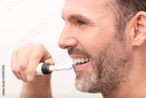 Man using electric toothbrush