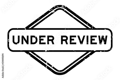 Grunge black under review word rubber seal stamp on white background