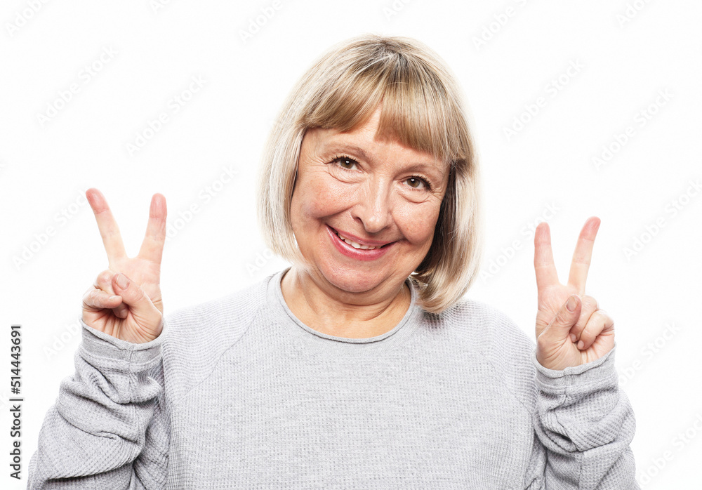 Old woman laugh and showing peace or victory sign at camera. Emotion and feelings. Old woman laugh and showing peace or victory sign at camera. Emotion and feelings.