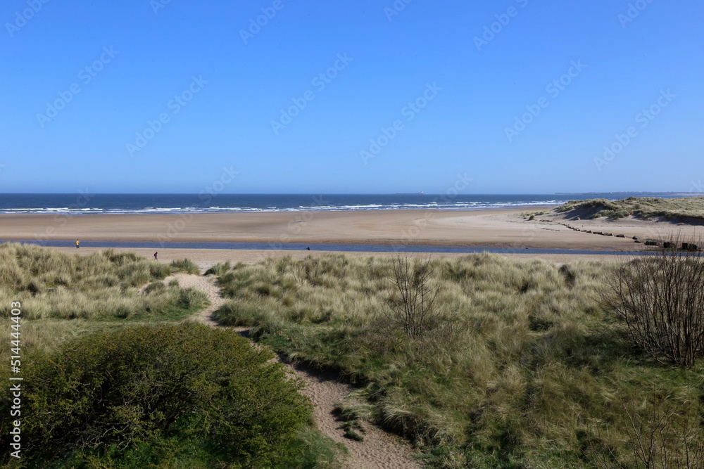 Dunes and Beach at Alnmouth where the river Aln meets the North Sea in Northumberland, UK.