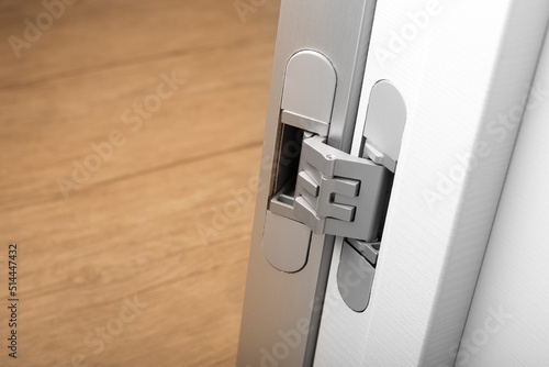 Modern aluminum door hinges on white doors, close-up. copy space, place for text photo
