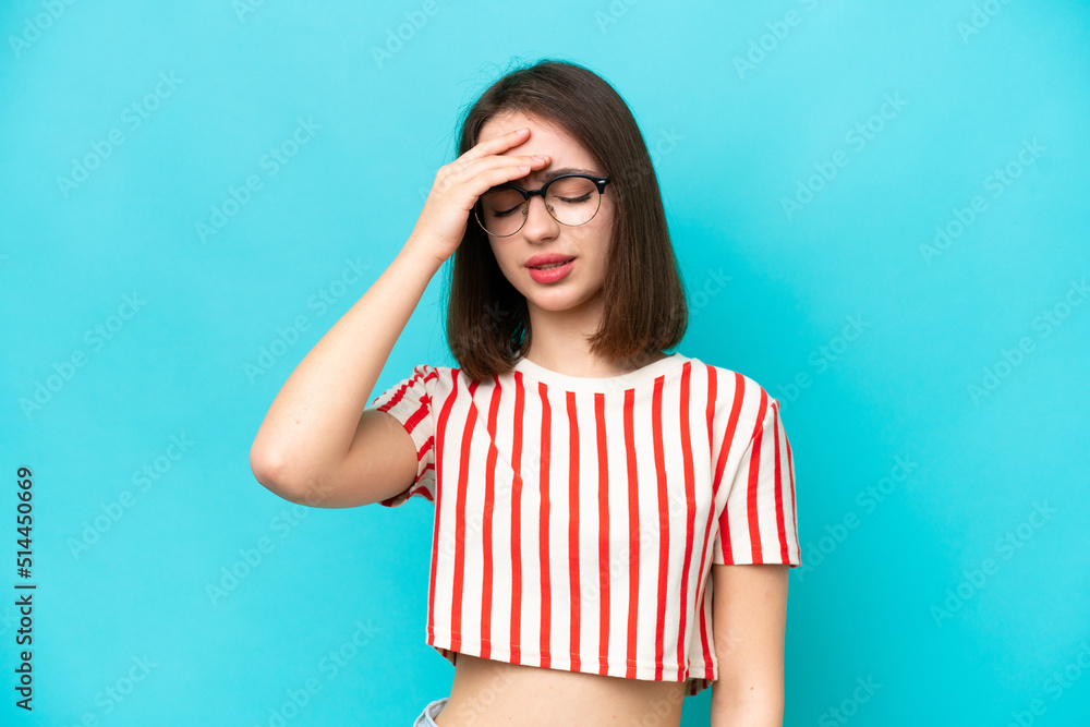 Young Ukrainian woman isolated on blue background with headache Young Ukrainian woman isolated on blue background with headache