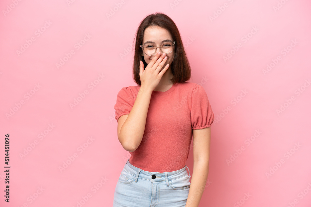Young Ukrainian woman isolated on pink background happy and smiling covering mouth with hand Young Ukrainian woman isolated on pink background happy and smiling covering mouth with hand
