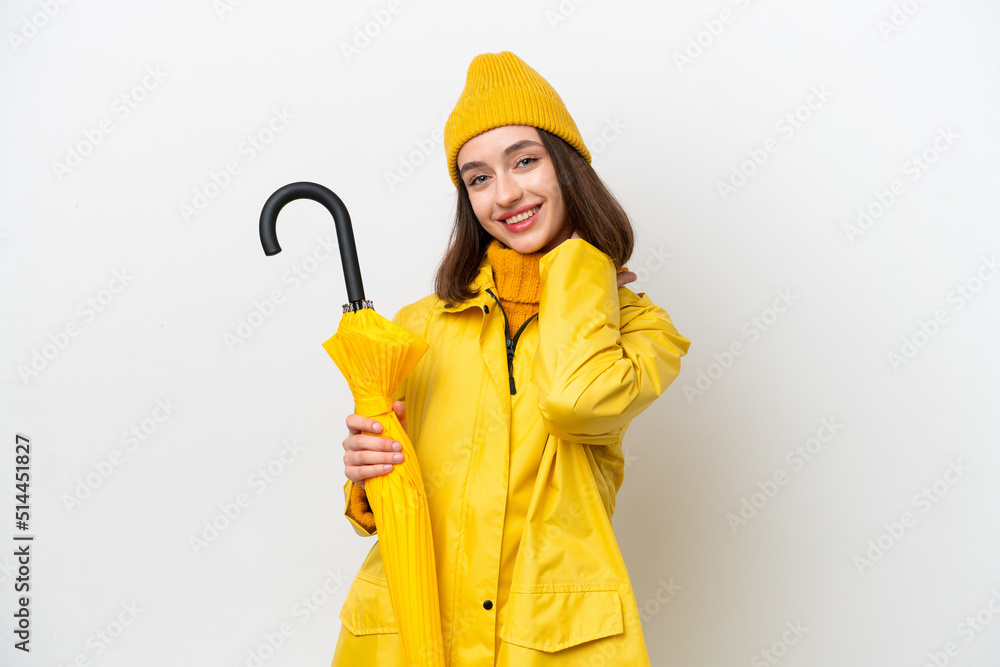 Young Ukrainian woman with rainproof coat and umbrella isolated on white background laughing Young Ukrainian woman with rainproof coat and umbrella isolated on white background laughing