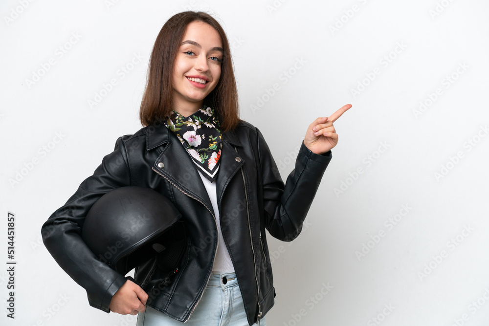 Young Ukrainian woman with a motorcycle helmet isolated on white background pointing finger to the side Young Ukrainian woman with a motorcycle helmet isolated on white background pointing finger to the side