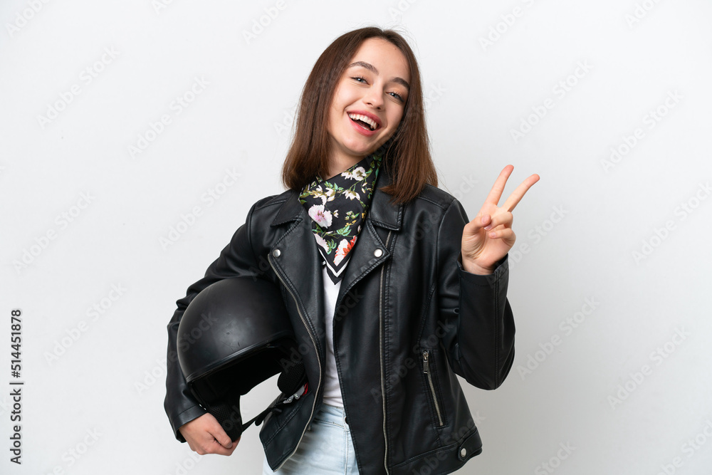Young Ukrainian woman with a motorcycle helmet isolated on white background smiling and showing victory sign Young Ukrainian woman with a motorcycle helmet isolated on white background smiling and showing victory sign