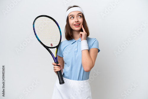 Young Ukrainian tennis player woman isolated on white background thinking an idea while looking up © luismolinero