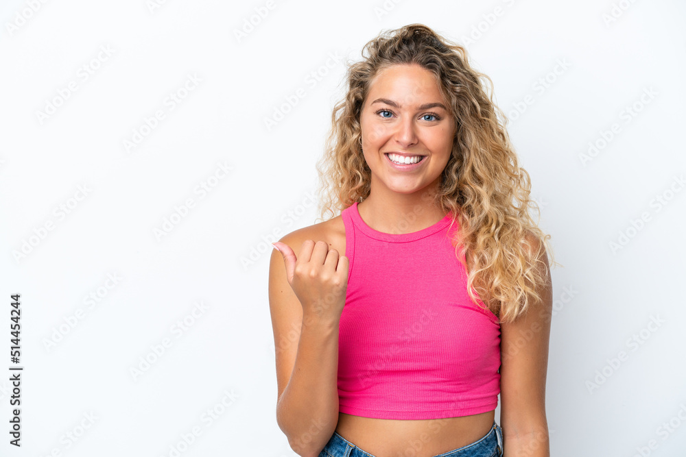 Girl with curly hair isolated on white background pointing to the side to present a product Girl with curly hair isolated on white background pointing to the side to present a product