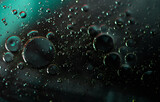 Abstract oil droplets in water reflecting the colors of a background to give a planet effect