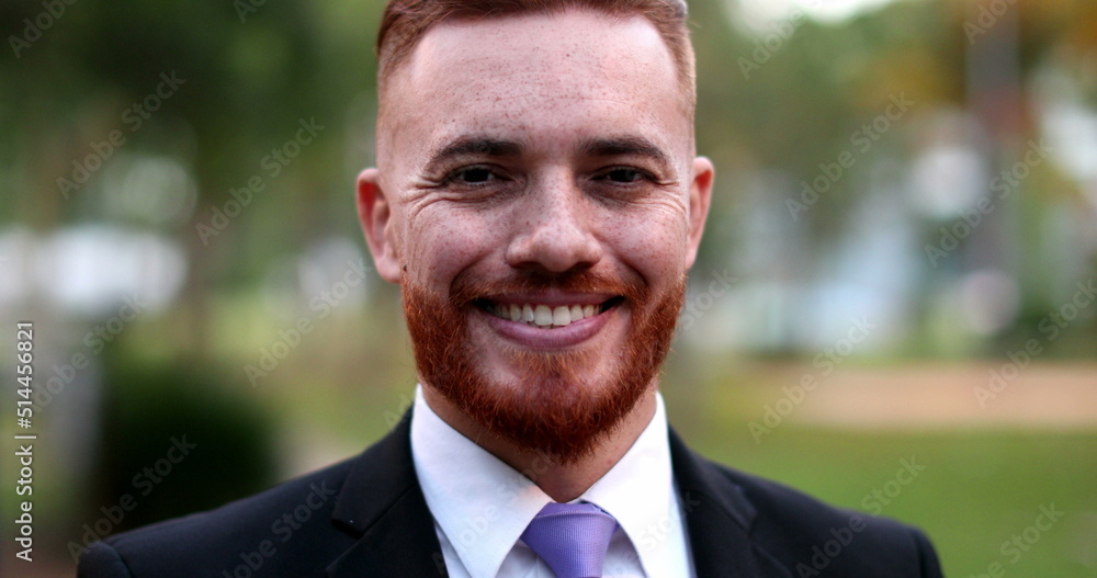Business man standing outside portrait smiling. Handsome ginger redhead executive Business man standing outside portrait smiling. Handsome ginger redhead executive