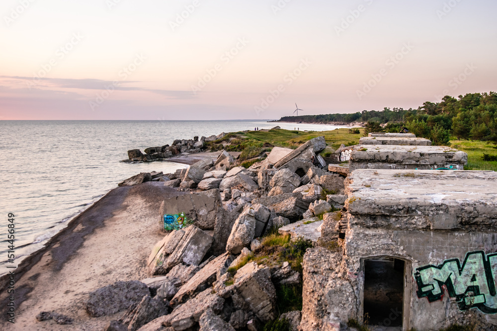Beach with rocks and abandoned buildings