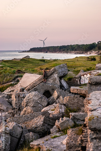 sunset on the coast with abandoned buildings