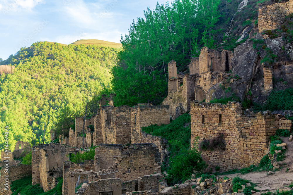 ruins of houses on a mountainside in the empty village of Gamsutl, Dagestan