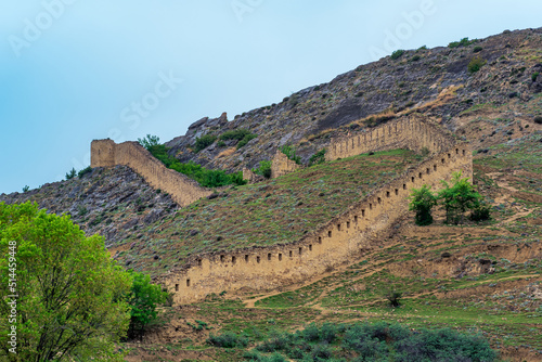 medieval fortress wall on a mountain slope, Shamil (Gunib) fortress in Dagestan photo