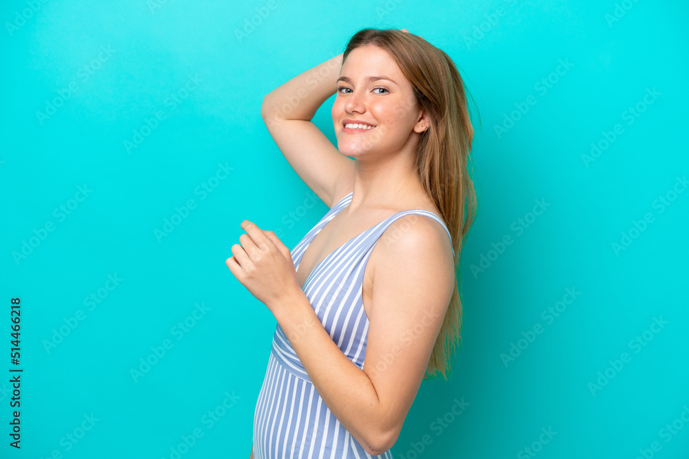 Young woman isolated on blue background in swimsuit in summer holidays Young woman isolated on blue background in swimsuit in summer holidays